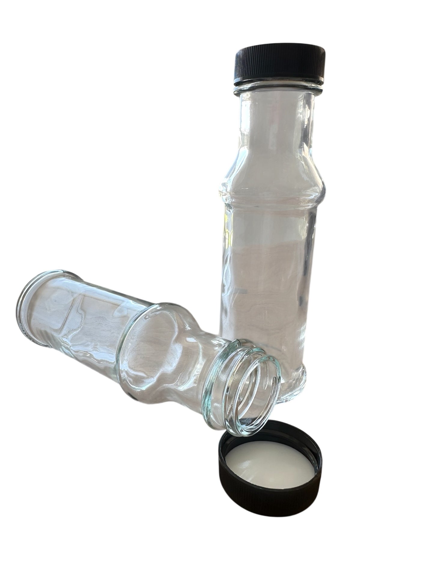 Two glass bottles with black caps on a white background