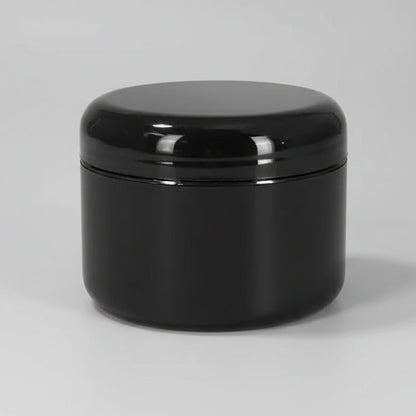 A black round-based jar with a dome cap, made of black plastic material.