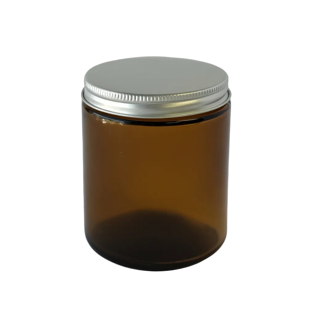 Amber glass jar with silver lid on a white background